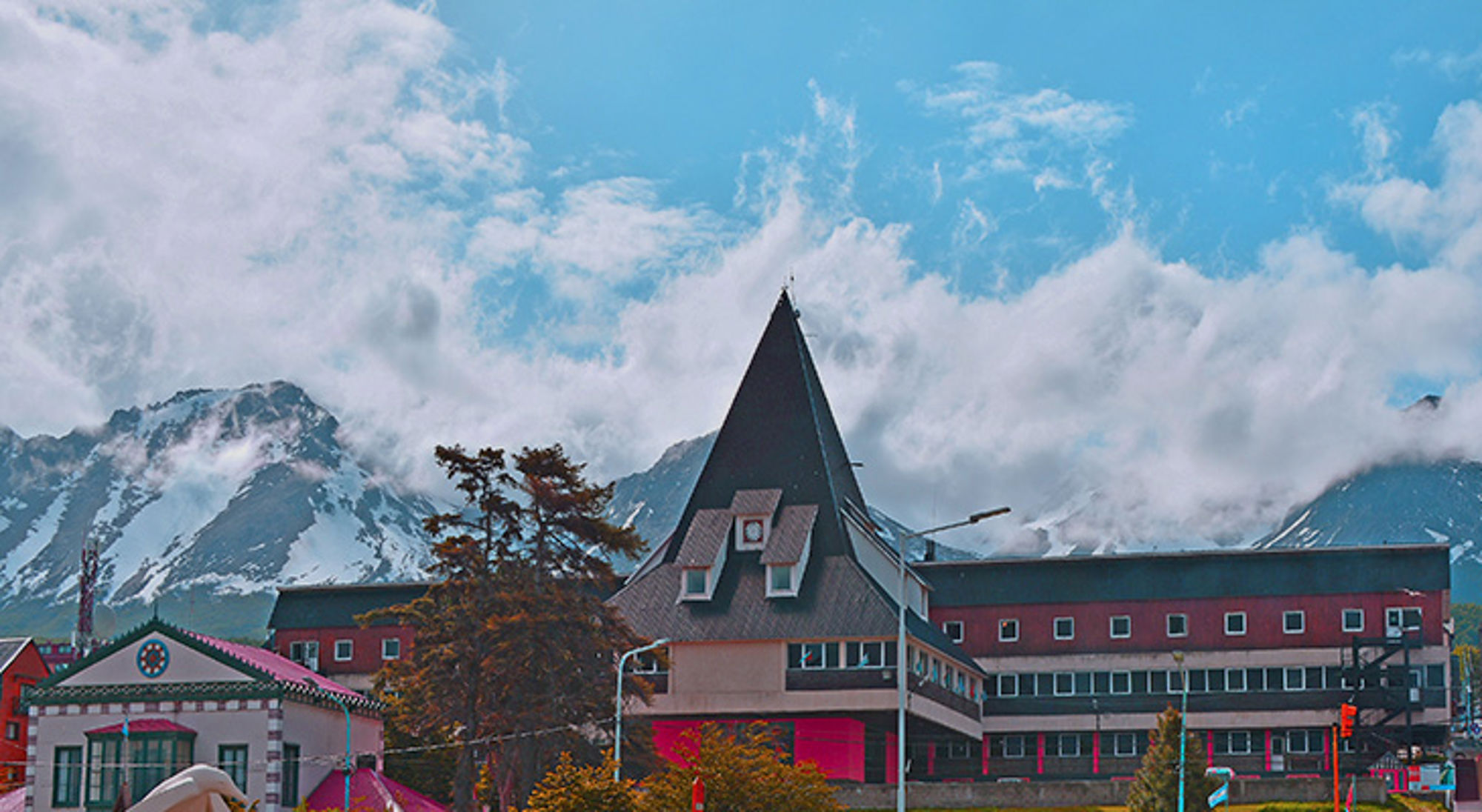 Gebouwen en bergtoppen in Ushuaia Stadsbeeld van Ushuaia met kleurrijke gebouwen en besneeuwde bergen op de achtergrond in Patagonië.